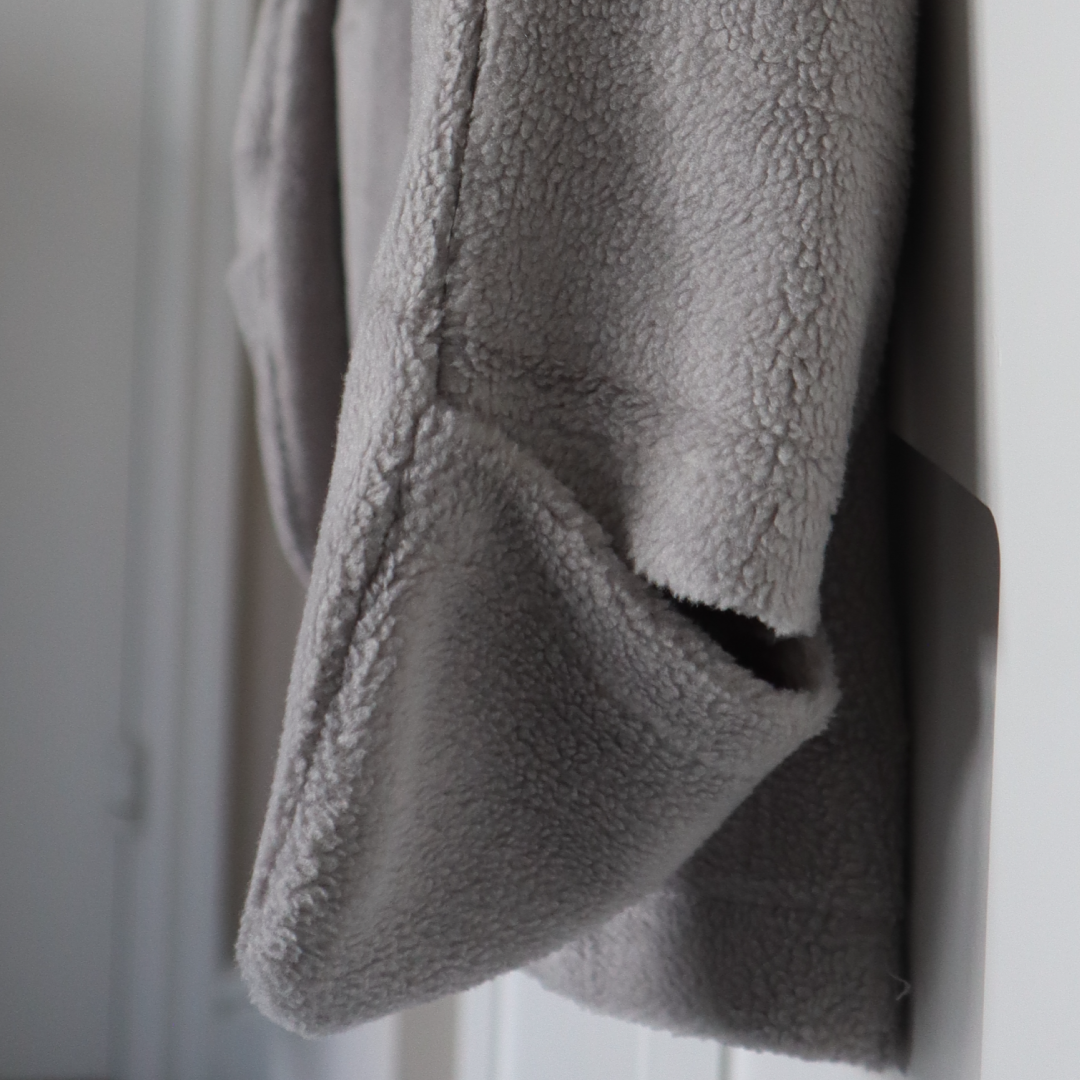 Gray fleece blanket draped 